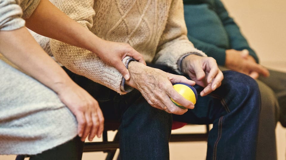 Old man holding a ball